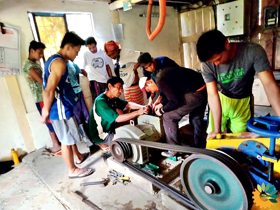 Locals help in the installation of the new generator for the SIBAT Micro-Hydro Power project in Malibcong, Abra.